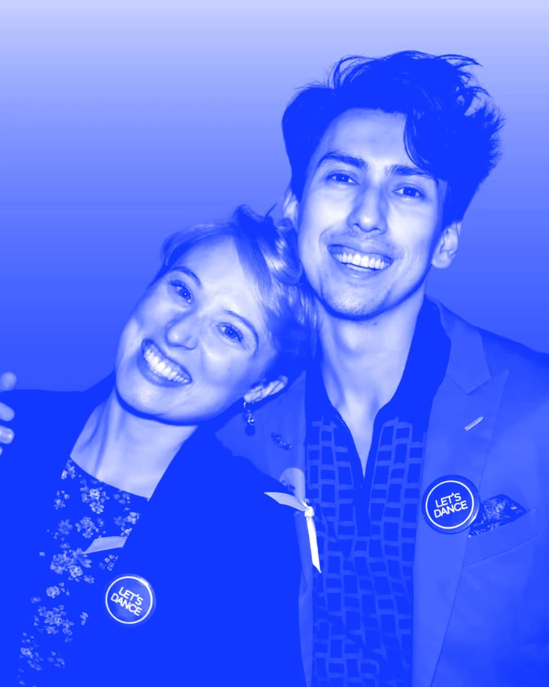 Orian and Bekah Breaux, smiling, heads together, wearing Let’s Dance buttons.